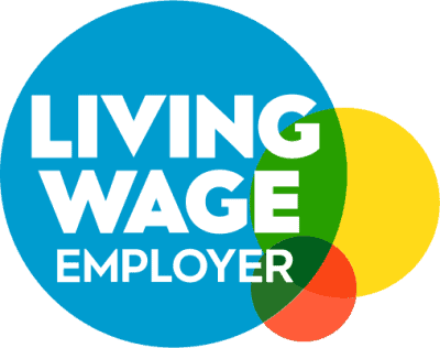 Logo with large blue circle containing bold white text "LIVING WAGE EMPLOYER," overlapping smaller green, yellow, and orange circles on the right side.