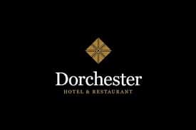 Logo for Dorchester Hotel & Restaurant featuring a gold geometric diamond shape above the white text on a black background.